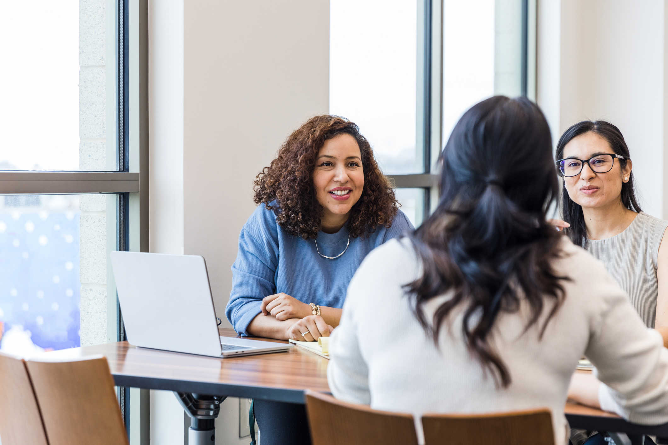 Women discussing patient engagement in interview-like meeting