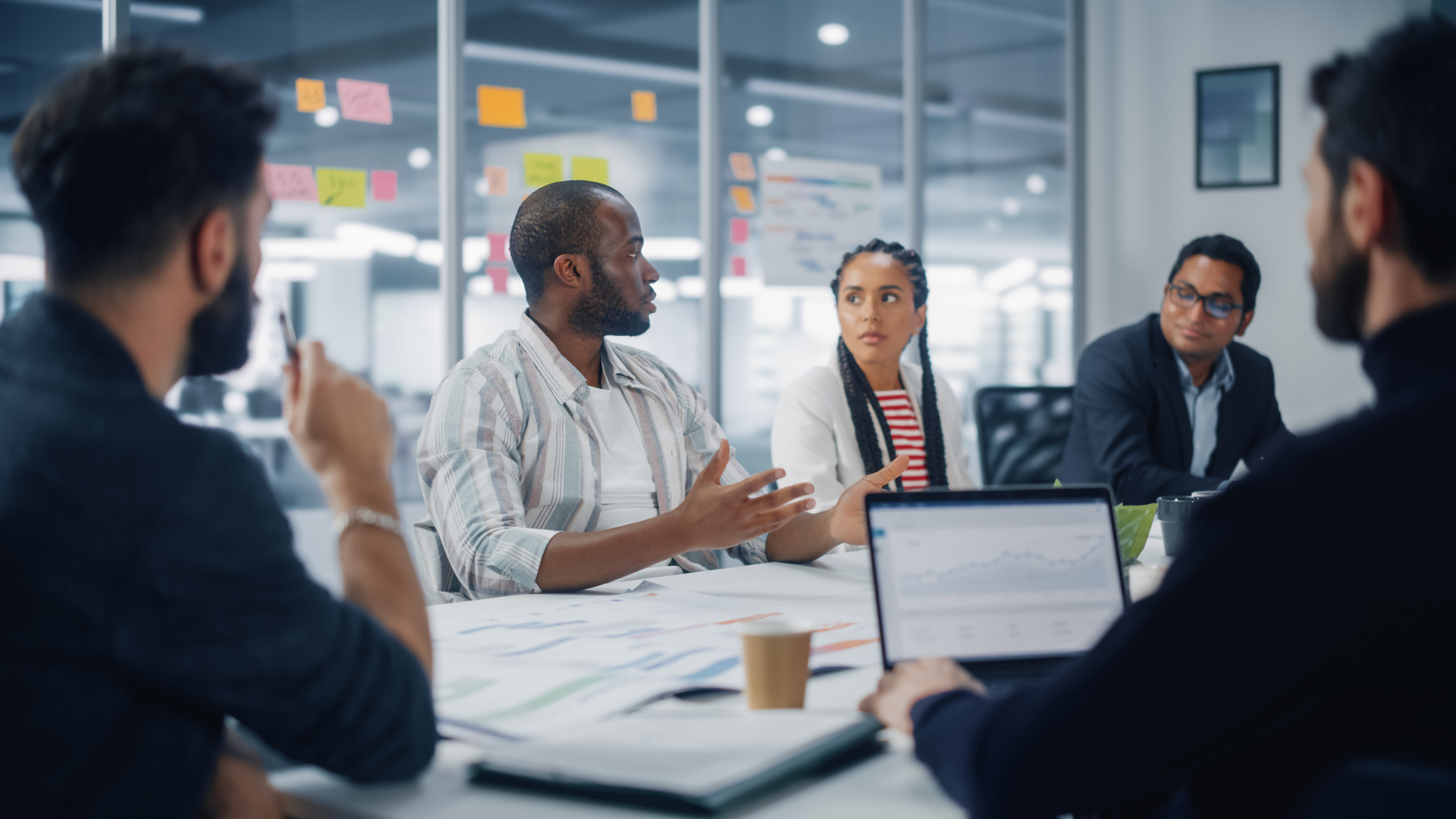 Group of businesspeople having a discussion about data being analyzed by the team